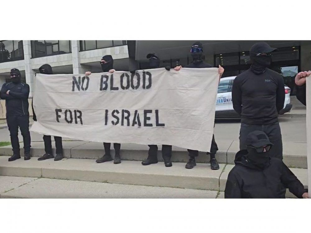 Police probe masked men chanting far-right slogans outside London city hall