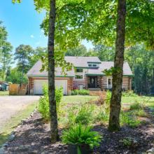 $899K for a rustic log home on more than 30 acres of land with private hiking trails